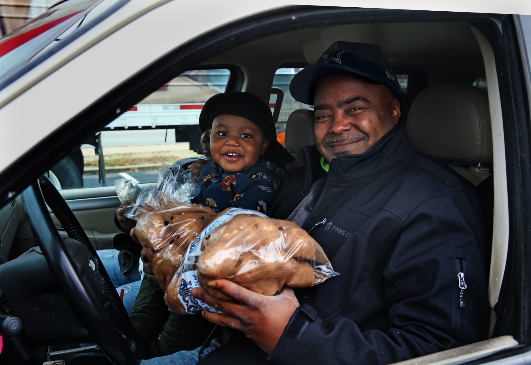 Volunteers hand out food at 'Thanksgiving Together' giveaway event